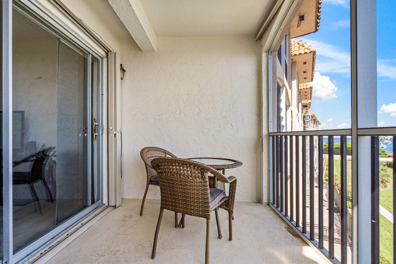 2871 North Ocean Boulevard, Unit C417 Boca Raton, FL 33431 - Photo 23 of 26 a view of a hallway with a door and chair