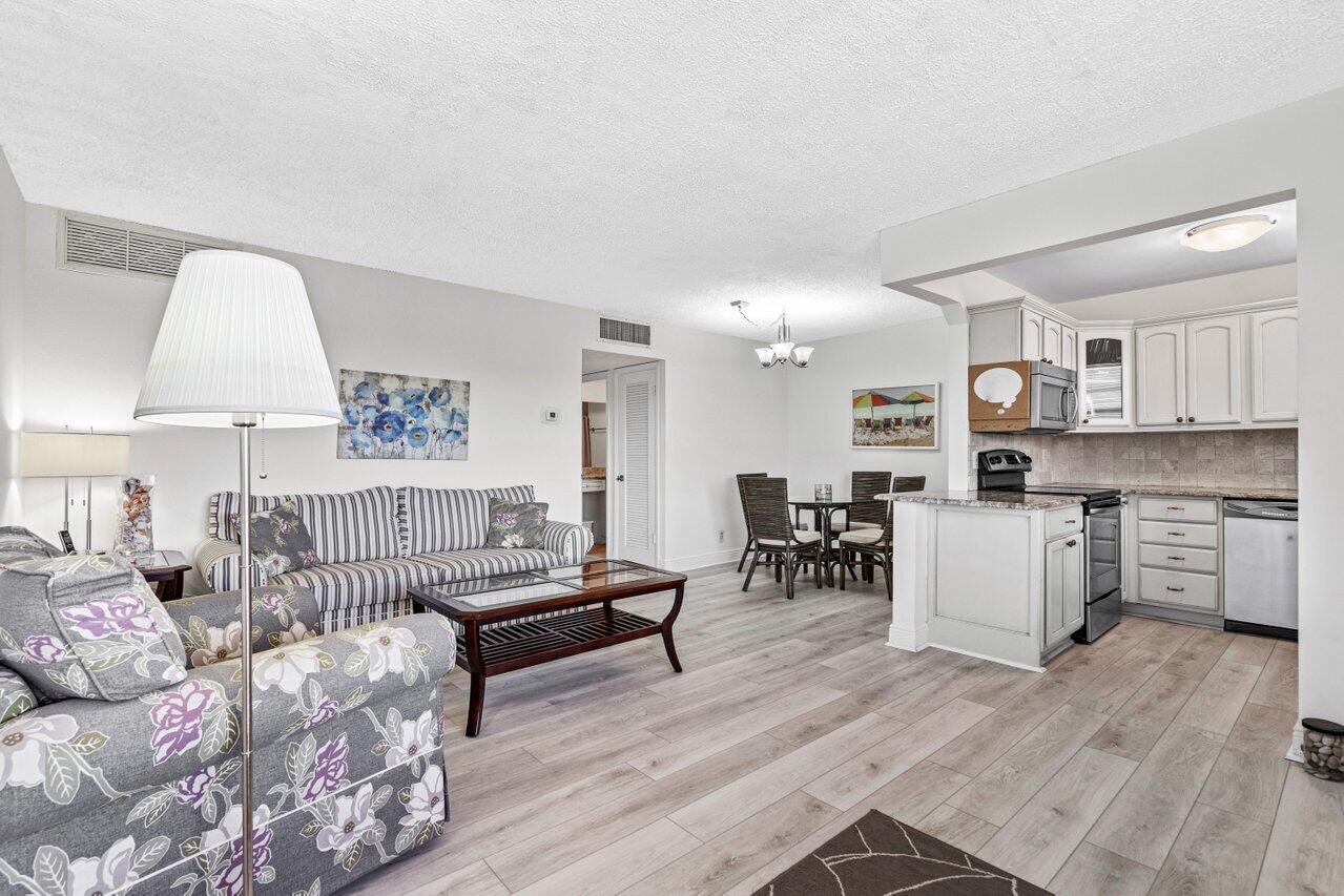 2871 North Ocean Boulevard, Unit C417 Boca Raton, FL 33431 - Photo 5 of 26 a living room with furniture and a wooden floor