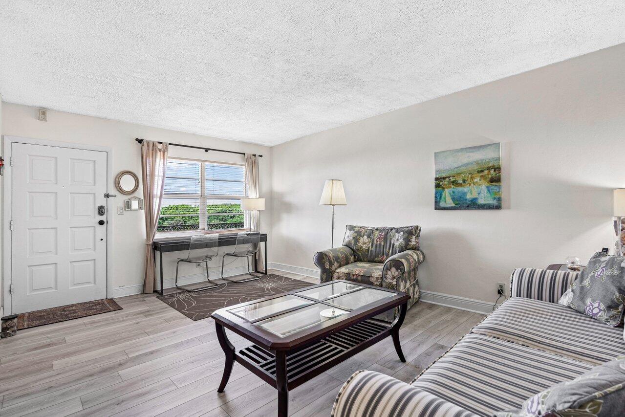 2871 North Ocean Boulevard, Unit C417 Boca Raton, FL 33431 - Photo 6 of 26 a living room with furniture and a wooden floor