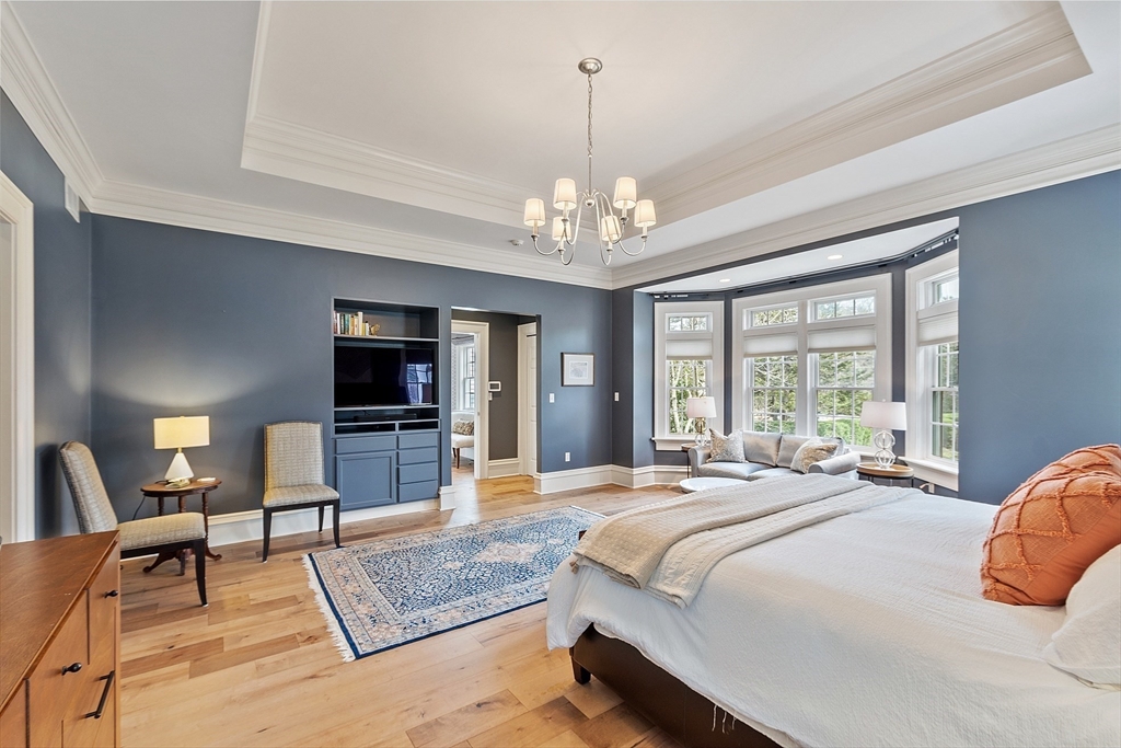 287 Westford Road Concord, MA 01742 - Photo 23 of 42 a spacious bedroom with a bed and a flat screen tv