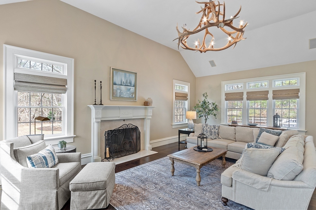 287 Westford Road Concord, MA 01742 - Photo 6 of 42 a living room with furniture a chandelier and a fireplace