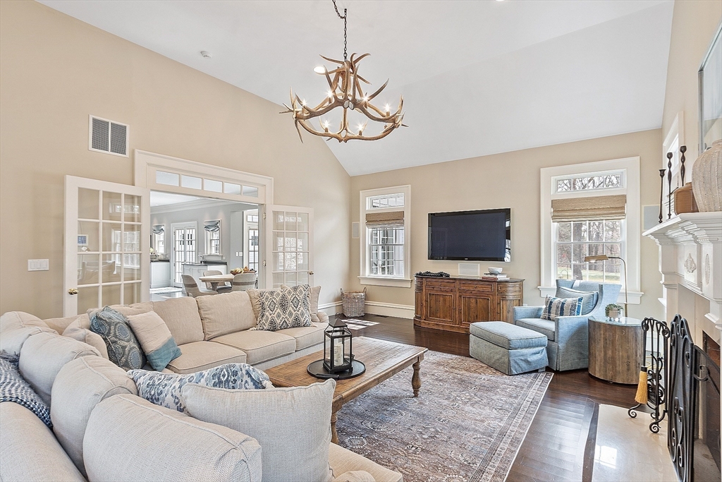 287 Westford Road Concord, MA 01742 - Photo 7 of 42 a living room with furniture a flat screen tv and a large window