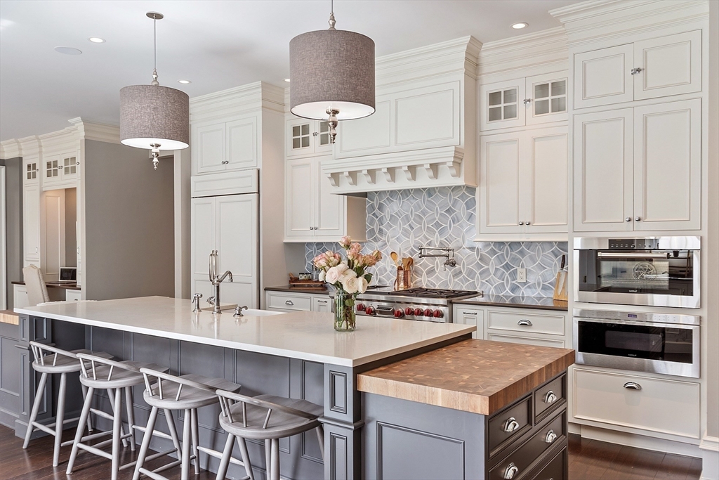 287 Westford Road Concord, MA 01742 - Photo 10 of 42 a kitchen with stainless steel appliances a sink a stove a refrigerator and cabinets