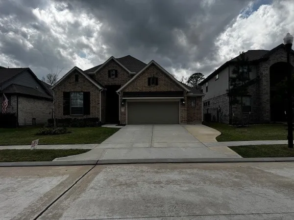 a front view of a house with a yard and a garage