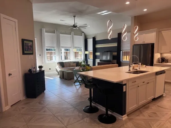 a kitchen with a counter space a sink appliances and cabinets
