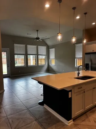 a kitchen with a sink stainless steel appliances and cabinets