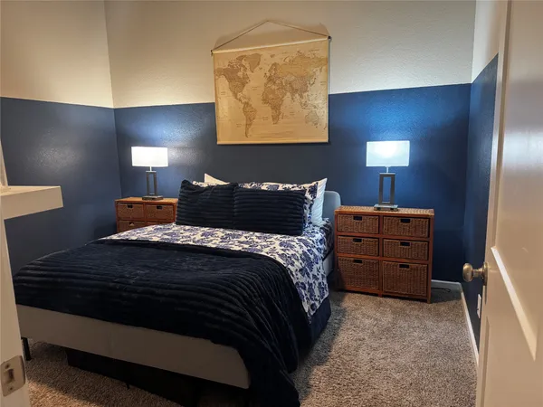 a bedroom with a bed and a night stand