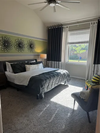 a bedroom with a bed a couch and a window