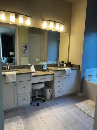 a bathroom with a sink vanity and mirror