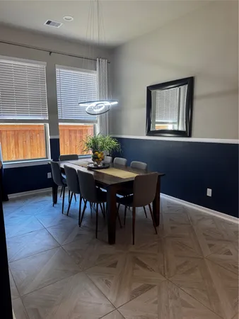 a dining room with furniture and window