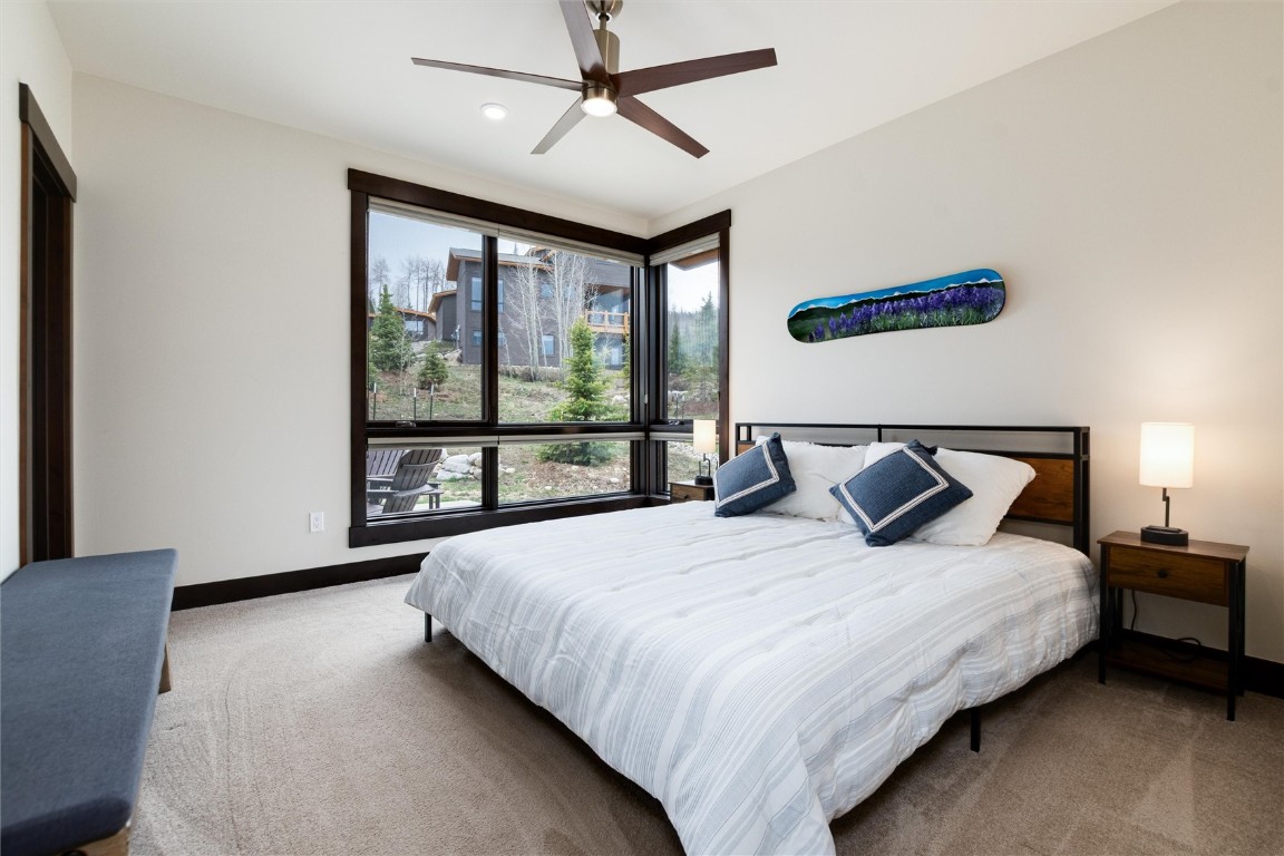 17 Vendette Road Silverthorne, CO 80498 - Photo 22 of 50 a bedroom with a large bed and a large window