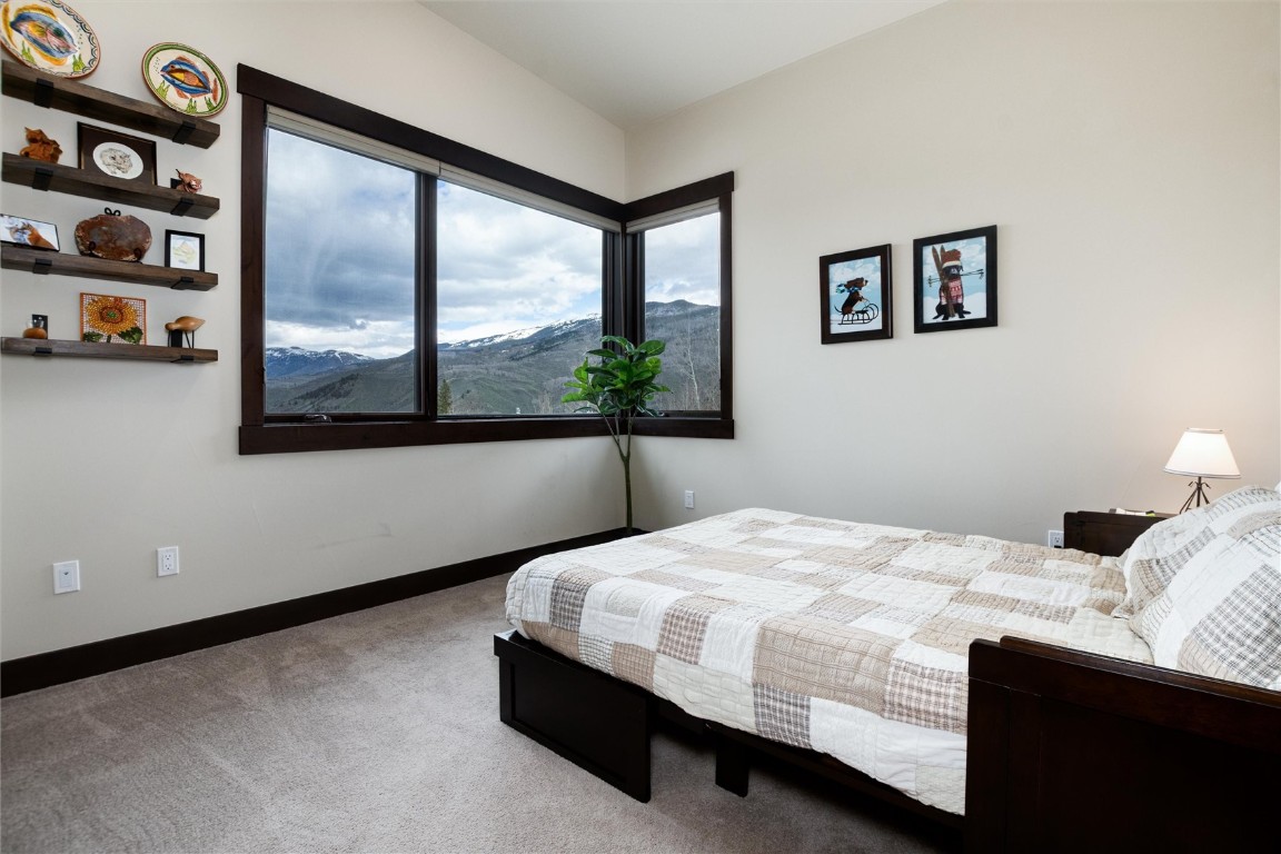 17 Vendette Road Silverthorne, CO 80498 - Photo 26 of 50 a bedroom with a bed painting and a large window