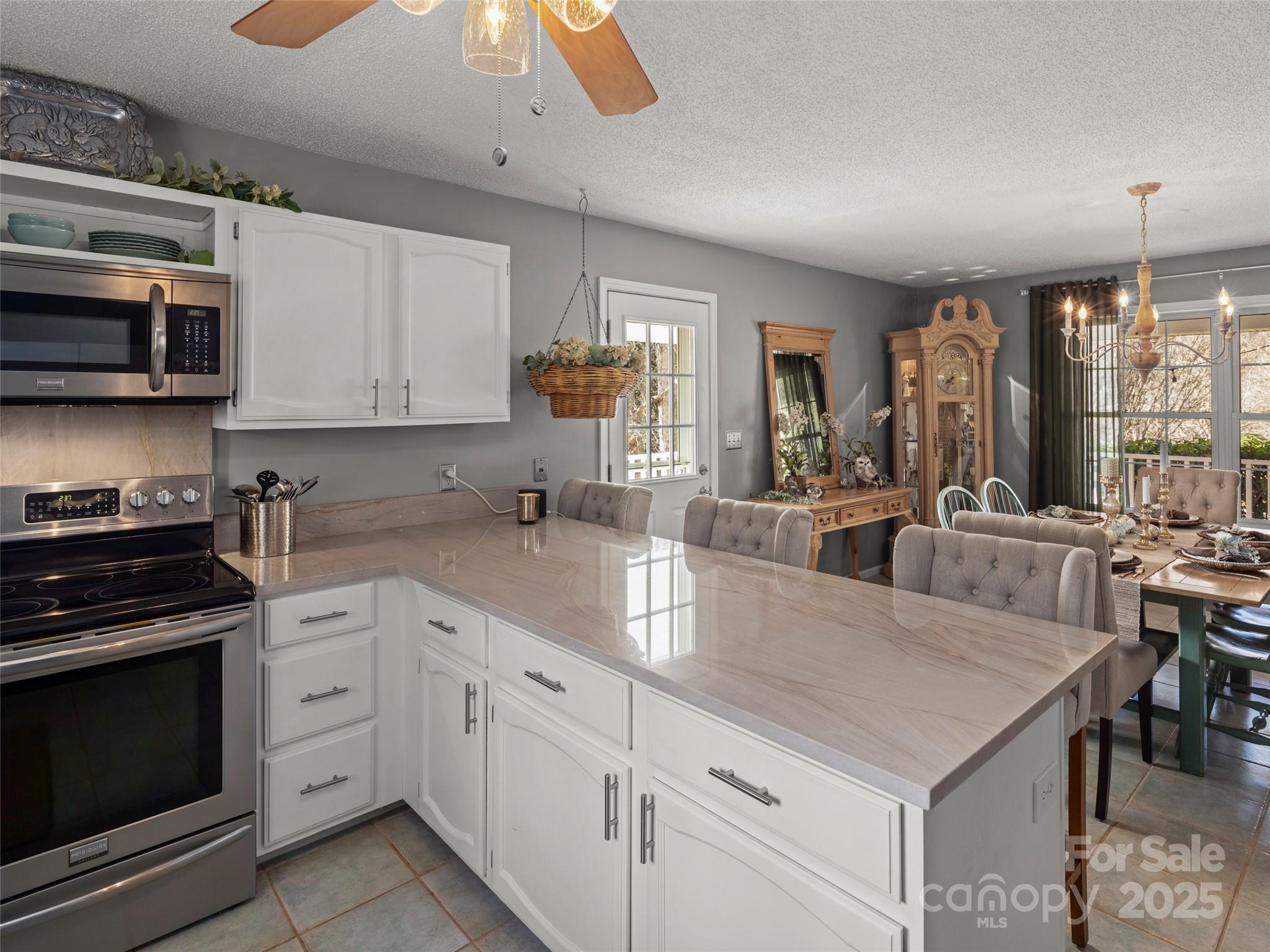 33 Ivy Cove Road Fairview, NC 28730 - Photo 14 of 36 a kitchen with stainless steel appliances granite countertop a stove sink and cabinets