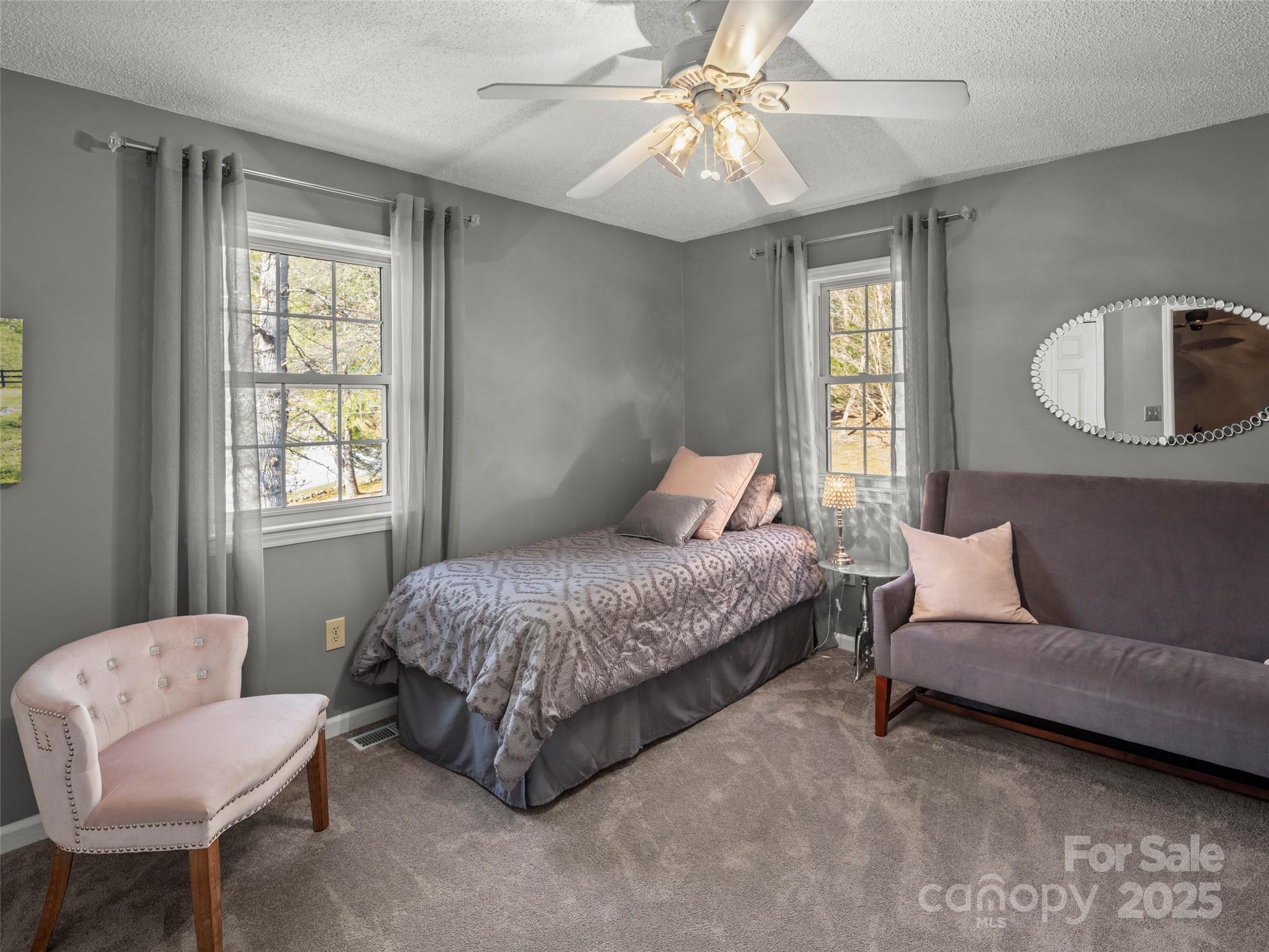 33 Ivy Cove Road Fairview, NC 28730 - Photo 29 of 36 a bedroom with a bed a chair and a window