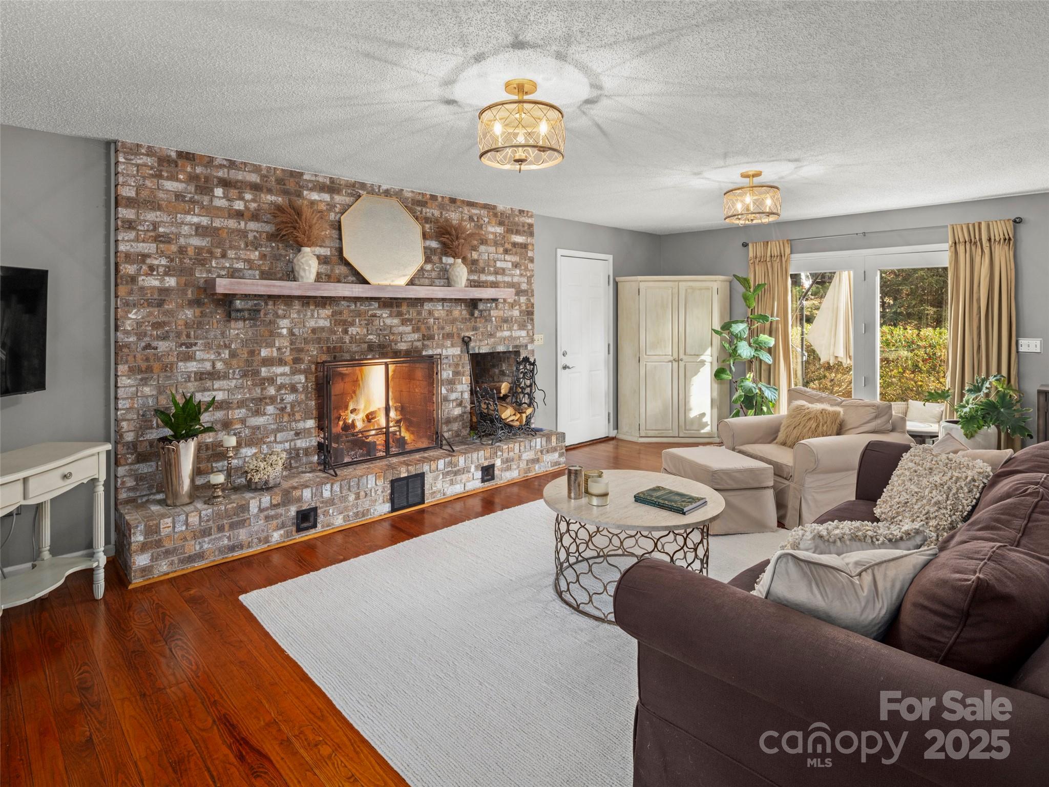 33 Ivy Cove Road Fairview, NC 28730 - Photo 7 of 36 a living room with furniture a fireplace and a flat screen tv