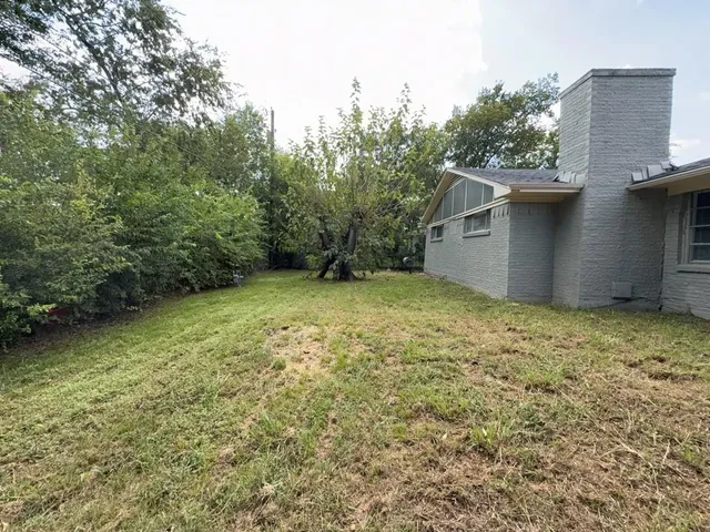 a backyard of a house with lots of green space
