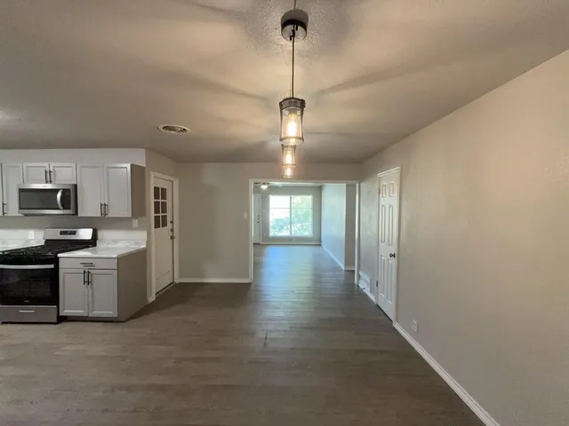 a view of a kitchen with a sink and dishwasher cabinets