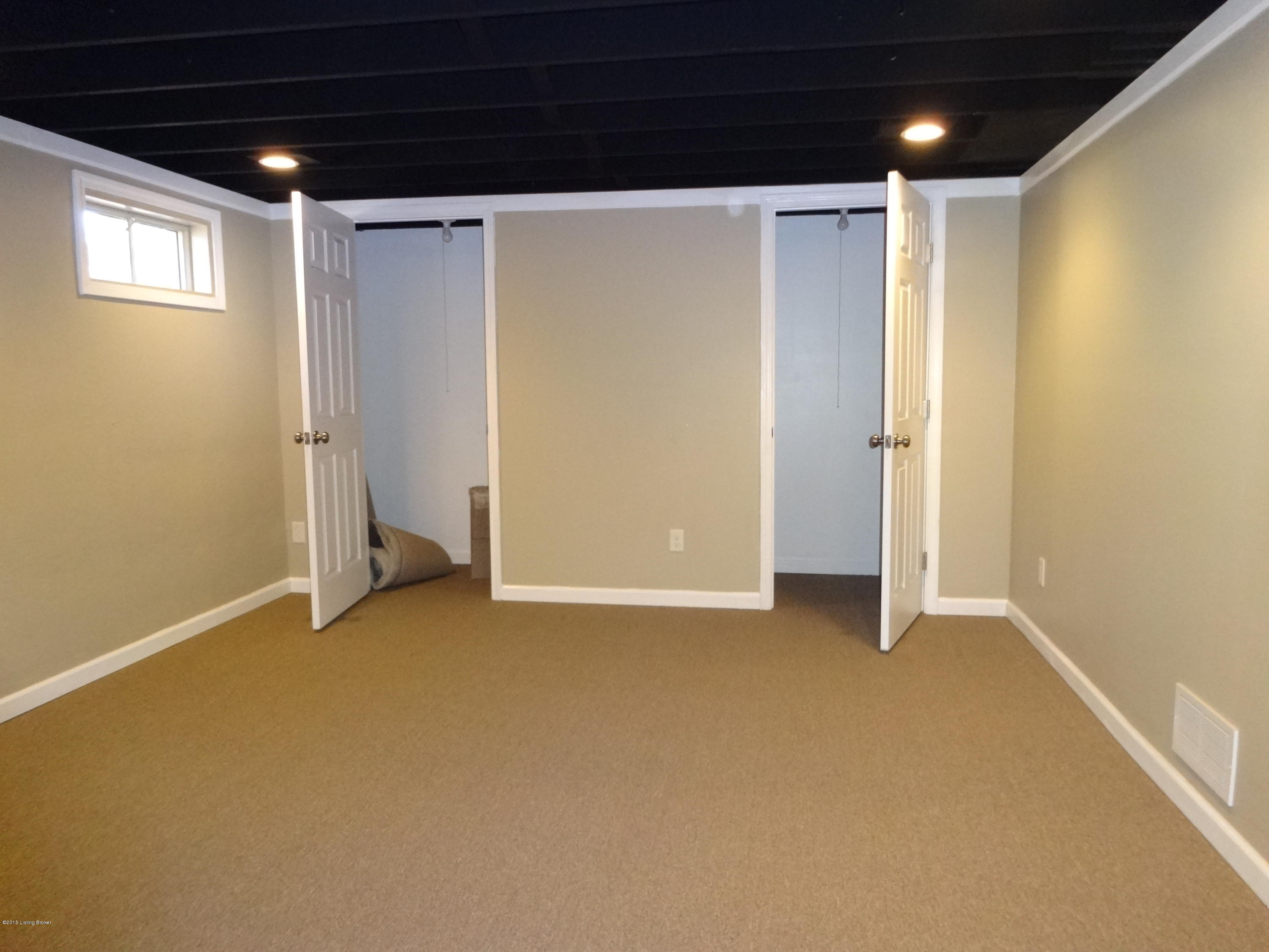 4402 Lowe Road Louisville, KY 40220 - Photo 27 of 44 NEW WALL PUT UP TO MAKE DOUBLE STORAGE CLOSETS FOR FAMILY ROOM. SEPARATE BEDROOM SUITE IS ON THE OTHER SIDE.