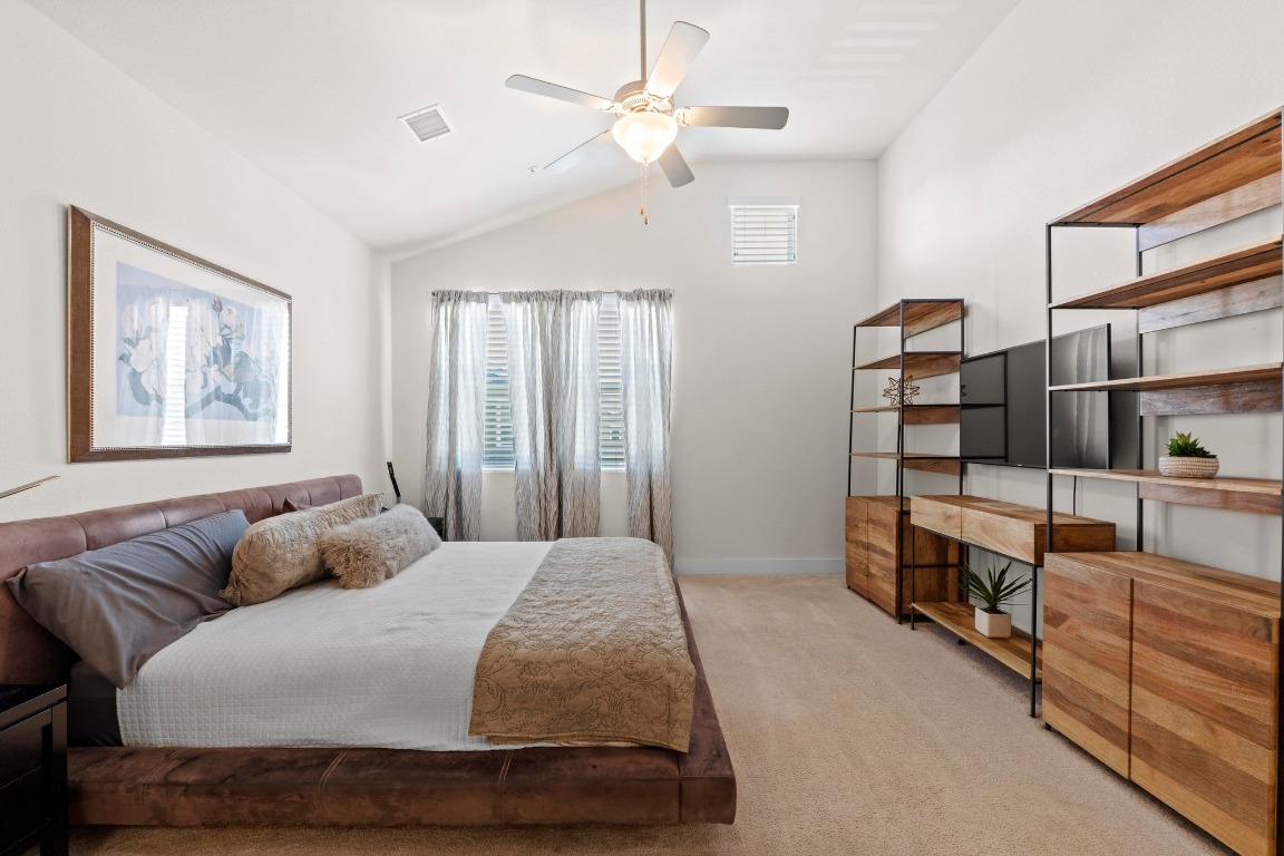 7407 Merrick Lane Austin, TX 78745 - Photo 16 of 34 a bedroom with a large bed and furniture