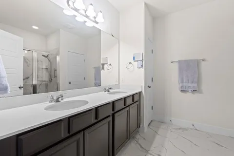 a bathroom with a sink double vanity and a mirror