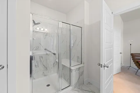 a bathroom with a glass shower door