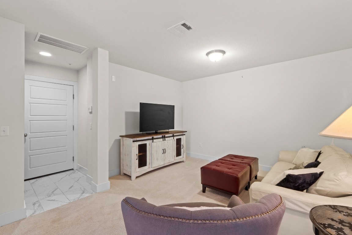 7407 Merrick Lane Austin, TX 78745 - Photo 22 of 34 a living room with furniture and a flat screen tv