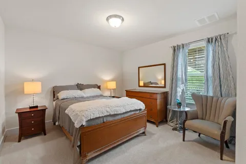 a bedroom with a bed and a couch