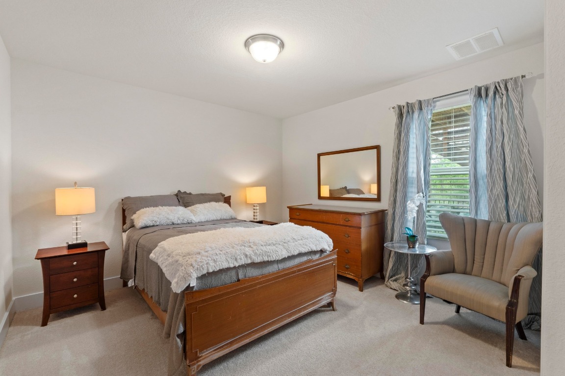 7407 Merrick Lane Austin, TX 78745 - Photo 24 of 34 a bedroom with a bed and a couch