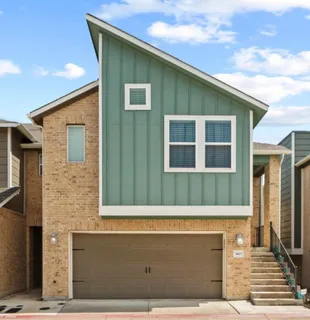 a front view of a house with large windows