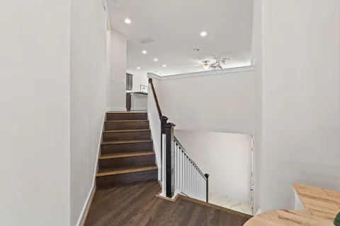 a view of entryway and hall with wooden floor