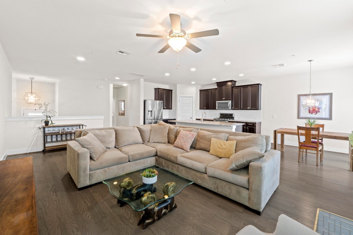 7407 Merrick Lane Austin, TX 78745 - Photo 7 of 34 a living room with furniture kitchen view and a chandelier
