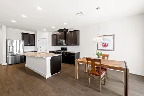 a kitchen with a sink cabinets and window