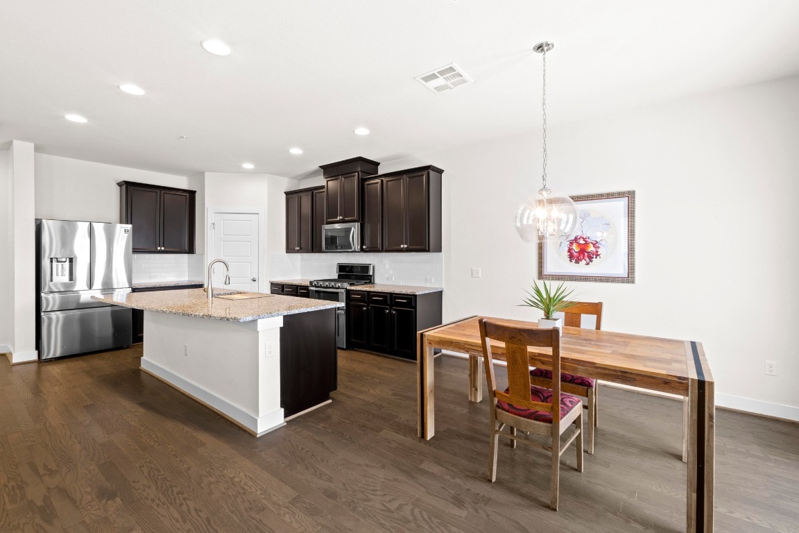 7407 Merrick Lane Austin, TX 78745 - Photo 9 of 34 a kitchen with a sink cabinets and window