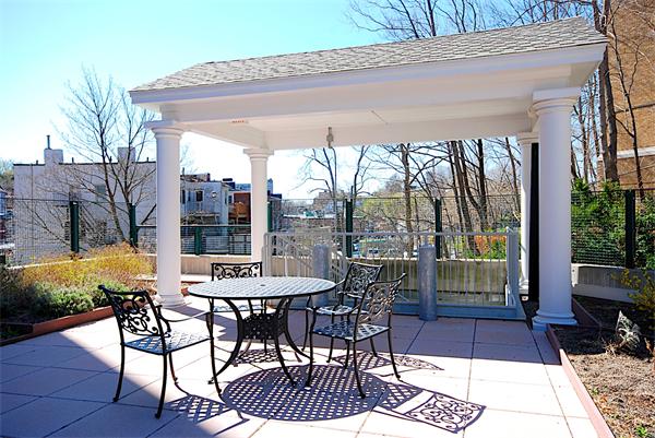 1600 Beacon Street, Unit 401 Brookline, MA 02446 - Photo 11 of 22 a view of a patio with a table and chairs