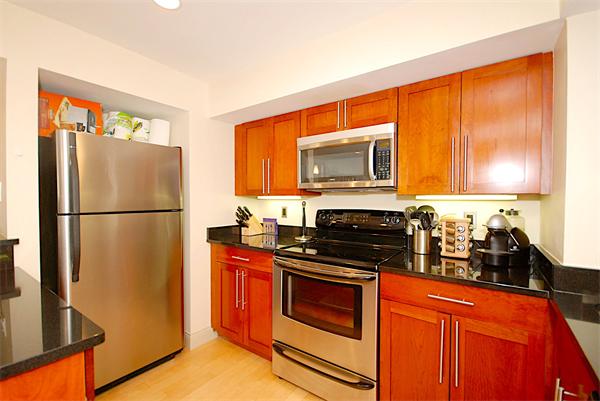 1600 Beacon Street, Unit 401 Brookline, MA 02446 - Photo 3 of 22 a kitchen with stainless steel appliances granite countertop a refrigerator stove and microwave