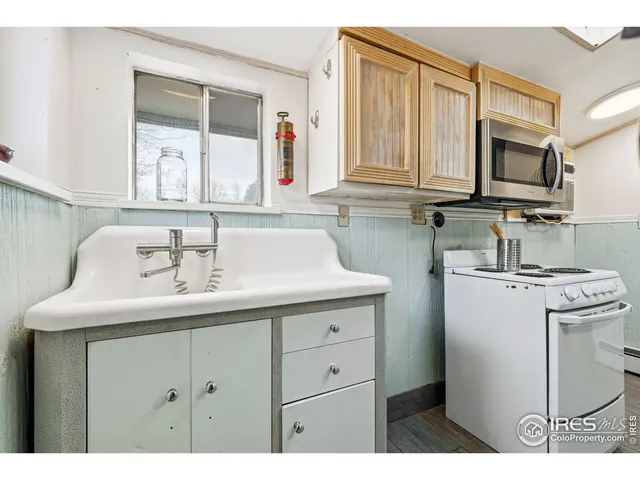 a kitchen with a sink stove and microwave