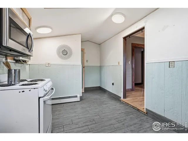 a view of a storage & utility room with a fridge