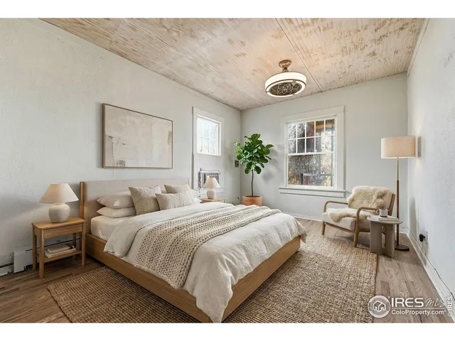 a view of a room with wooden floor and window