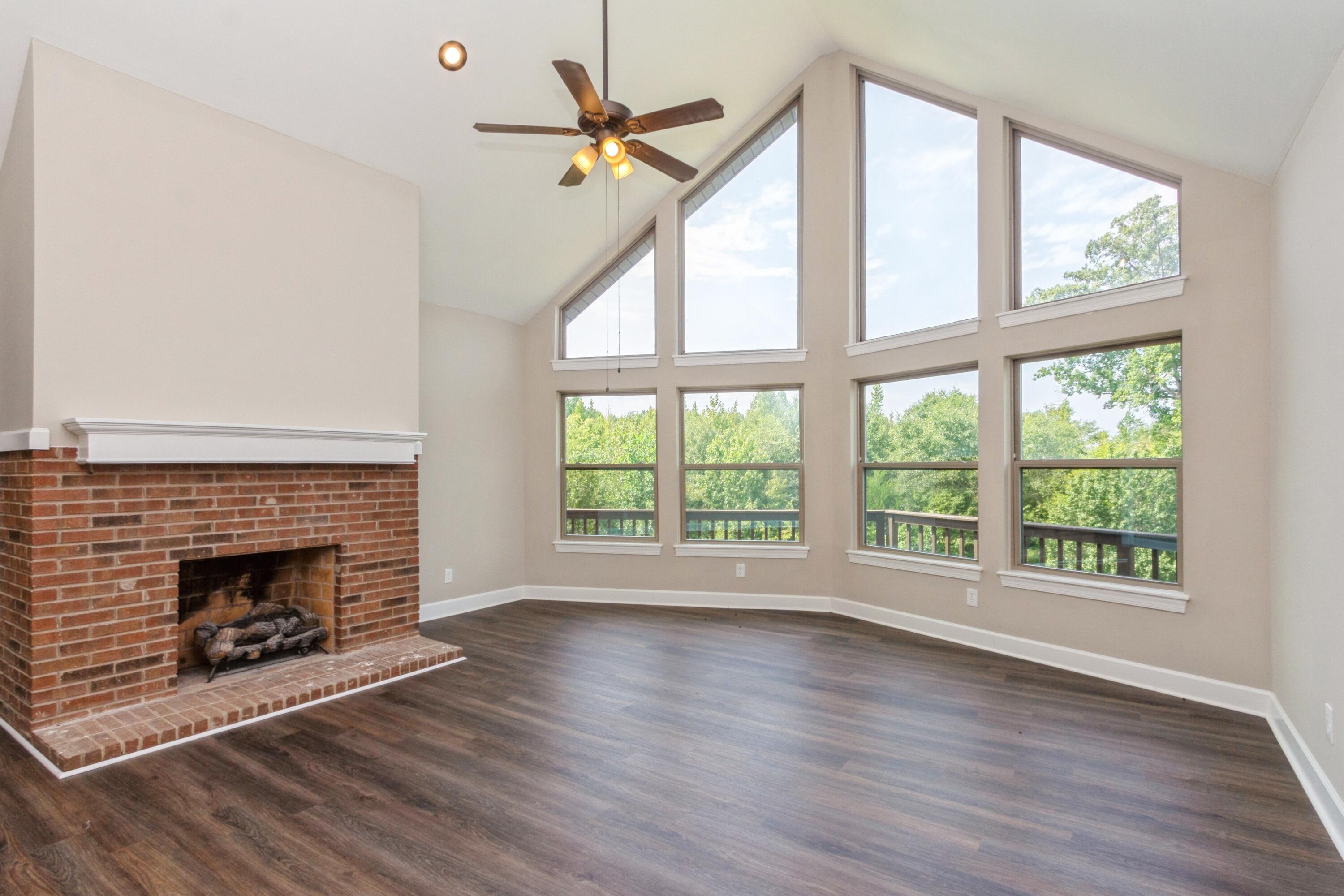 198 Hunters Run Edgefield, SC 29824 - Photo 7 of 31 a view of an empty room with wooden floor fireplace and a window