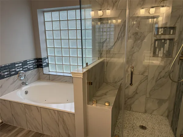 a bathroom with a bathtub and shower