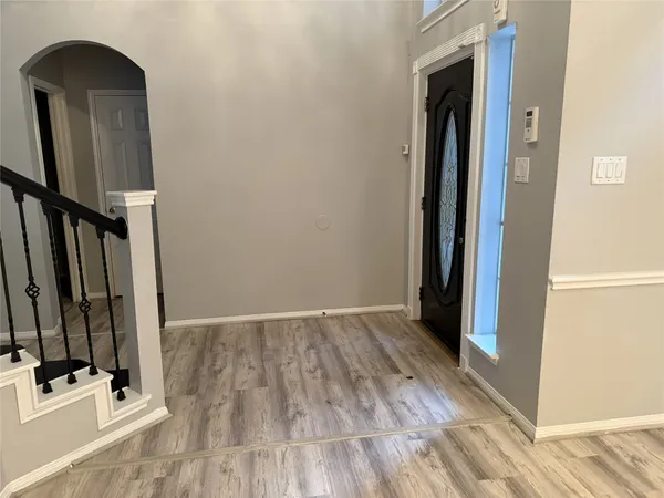 a view of an entryway with wooden floor