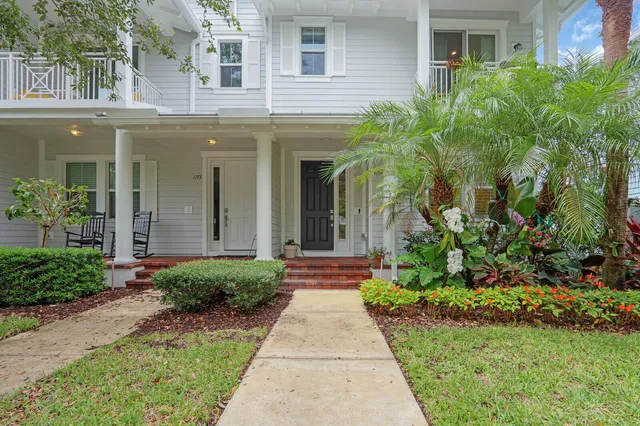 front view of a brick house with a small yard