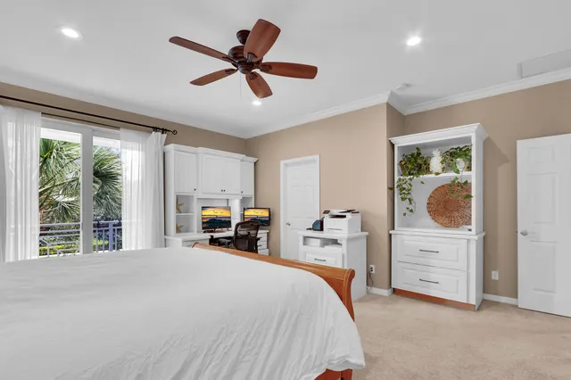 a bedroom with a large bed and a chandelier