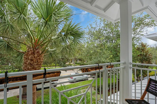 a view of a chair and tables in the balcony