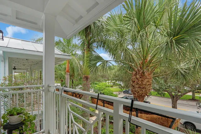 a view of a yard with plants and wooden fence