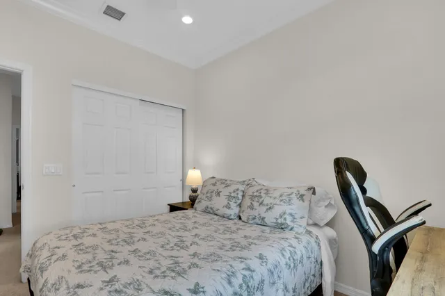 a bedroom with a bed and a wooden floor