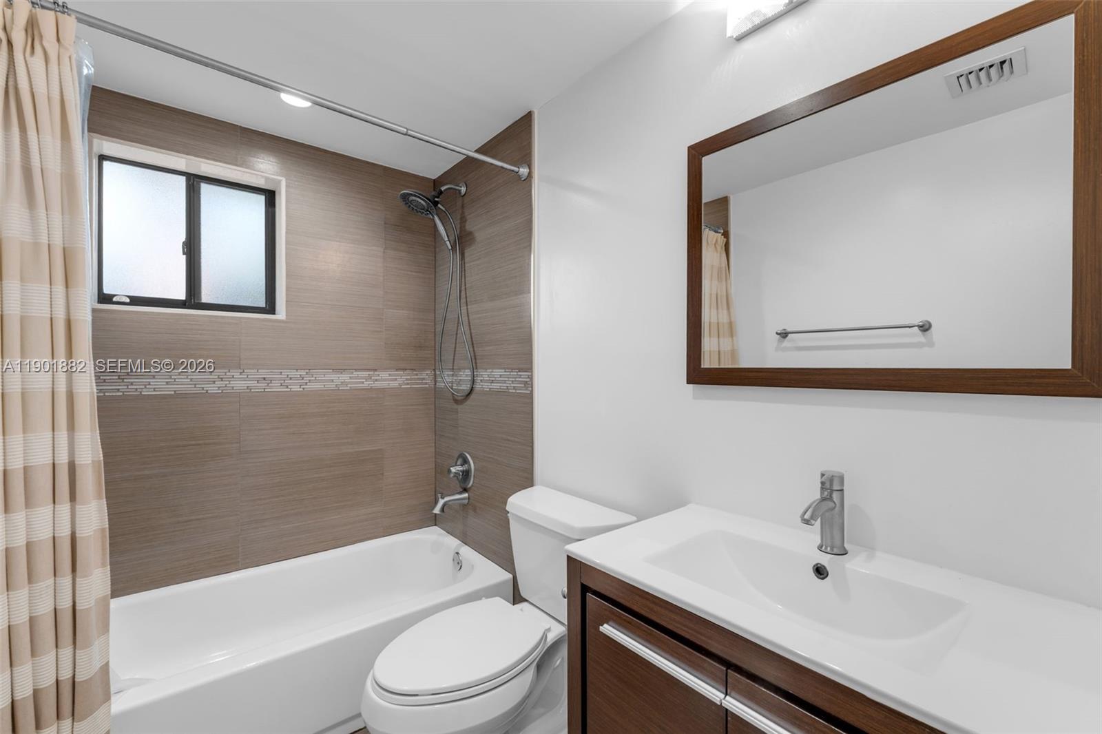8045 Southwest 107th Avenue, Unit 303 Miami, FL 33173 - Photo 11 of 37 a bathroom with a sink toilet and shower
