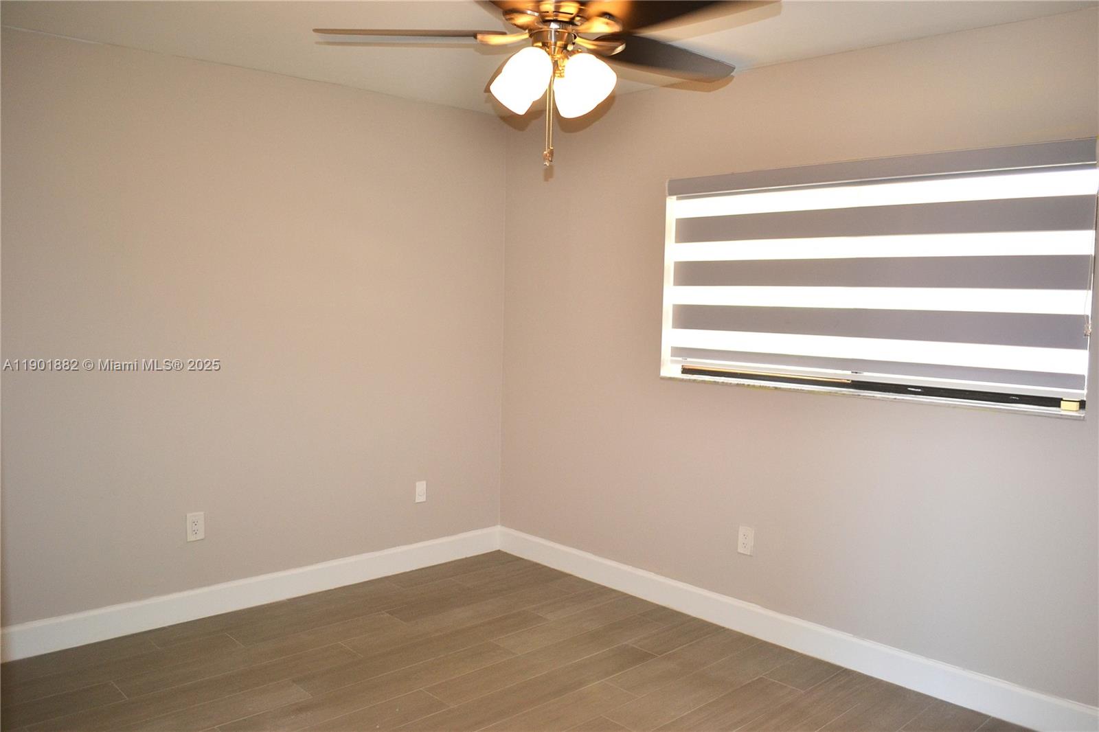 8045 Southwest 107th Avenue, Unit 303 Miami, FL 33173 - Photo 12 of 26 a view of a small space with wooden floor and a window