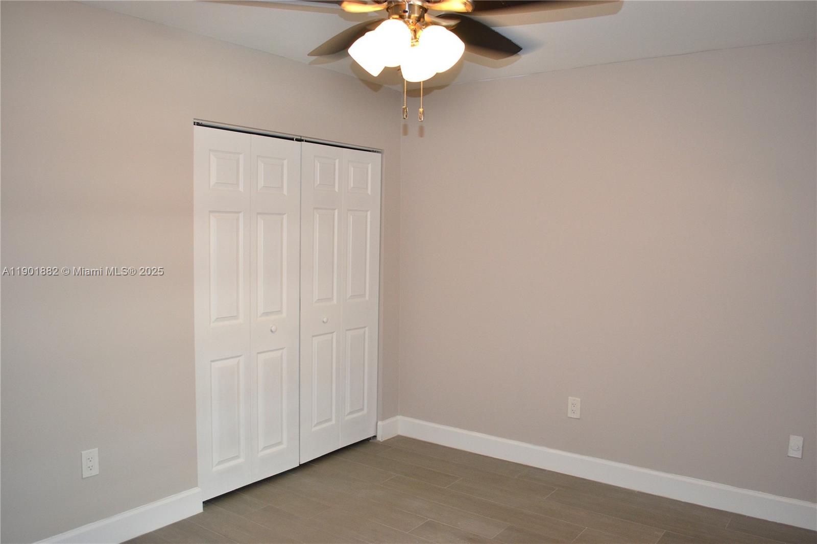 8045 Southwest 107th Avenue, Unit 303 Miami, FL 33173 - Photo 13 of 26 a view of a chandelier fan and closet in a room
