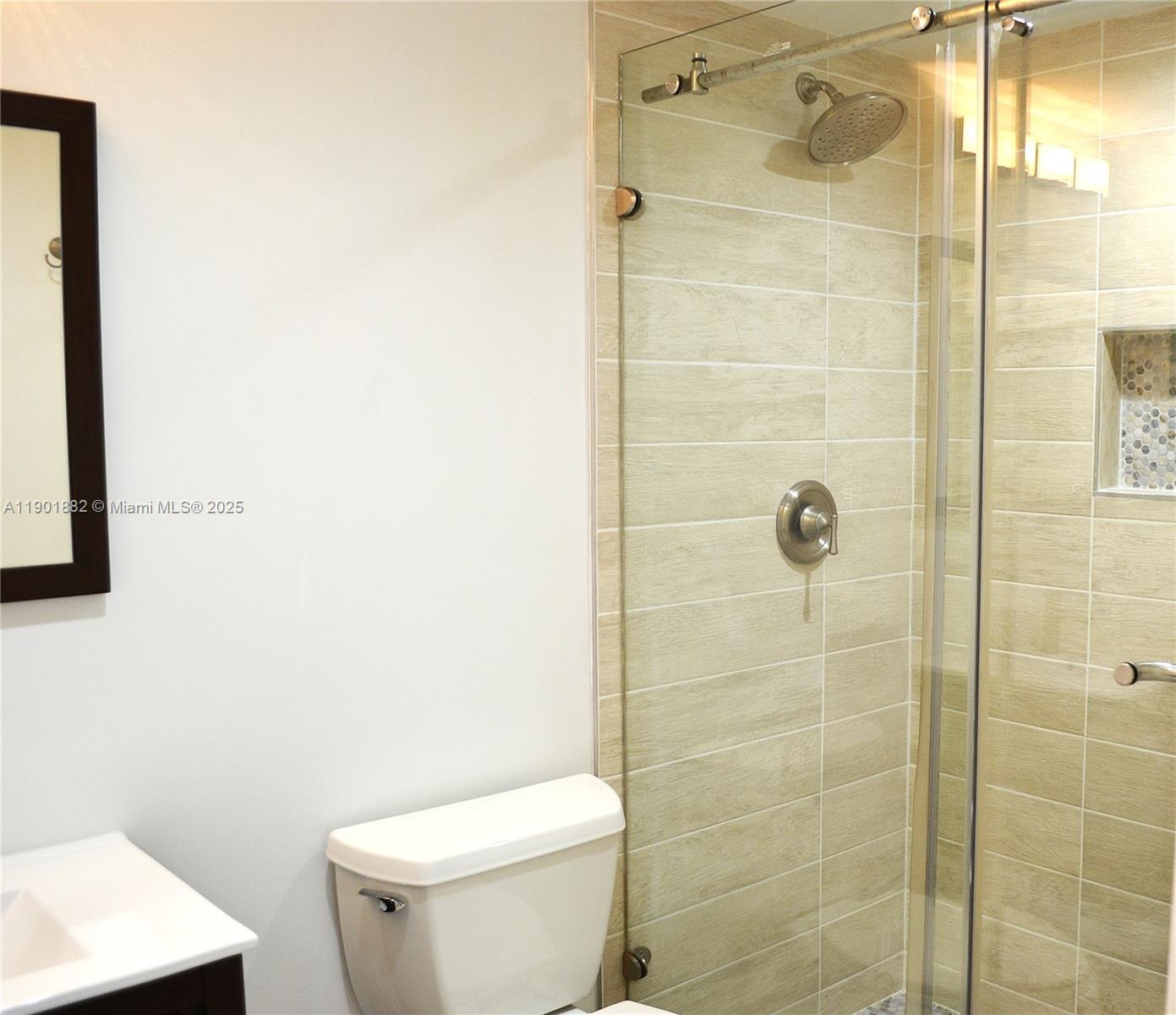 8045 Southwest 107th Avenue, Unit 303 Miami, FL 33173 - Photo 15 of 26 a white toilet sitting next to a bathroom sink